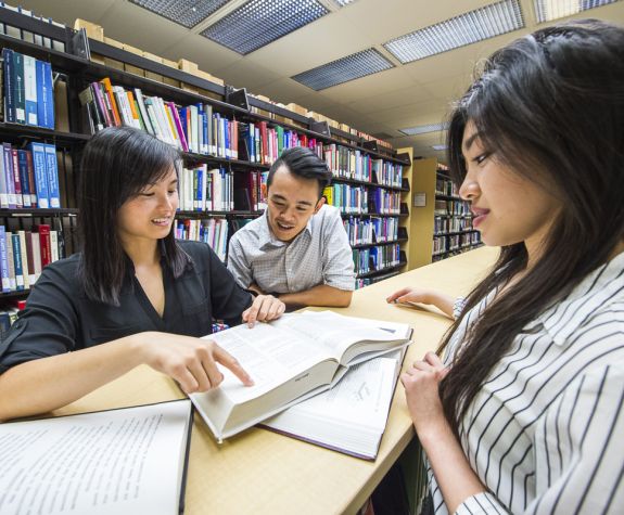 Pharmacy students studying in the library