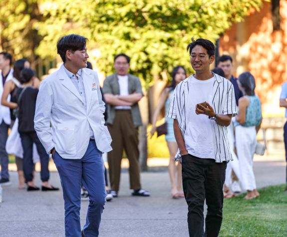 Two students walking on campus
