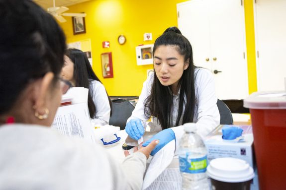 PharmD student with patient at health care outreach clinic