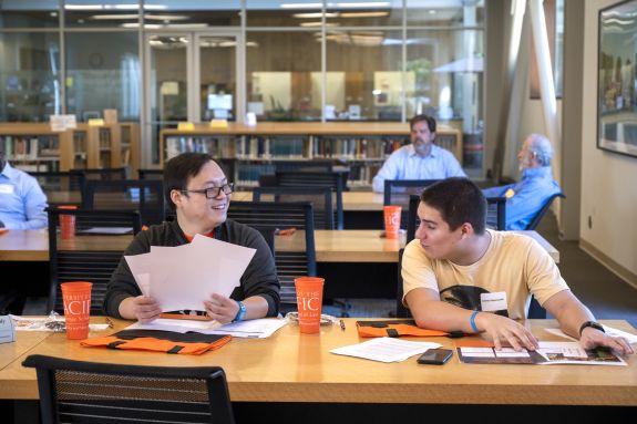 two students talking with each other 