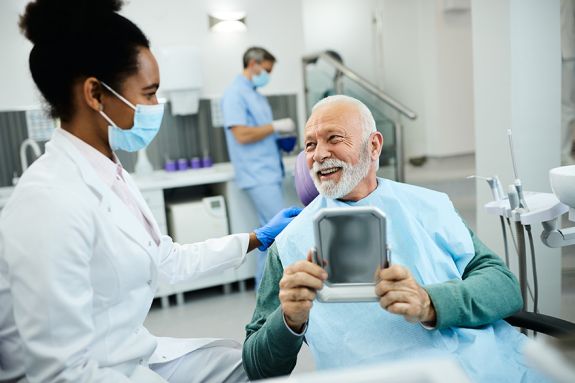 happy senior talking to dentist