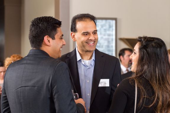 Alumni and faculty networking at event