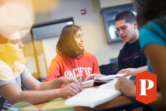 Students discussing their textbook