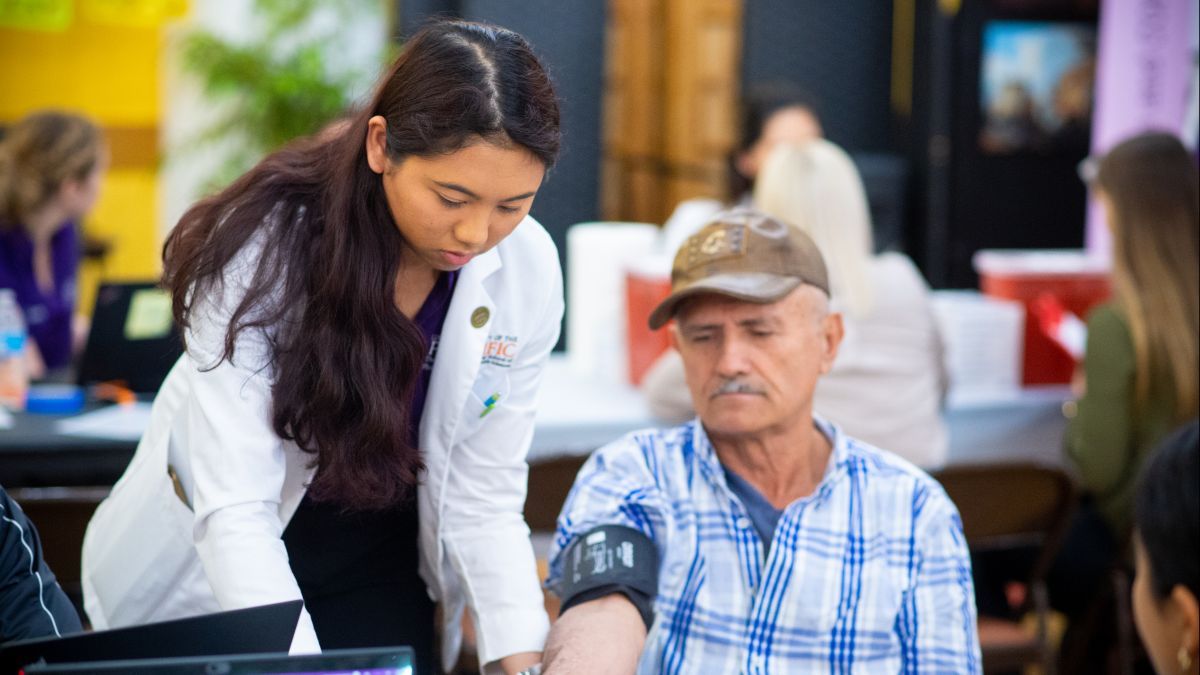 student helps patient