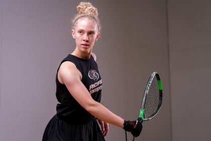 Annie Roberts stands on a racquetball court