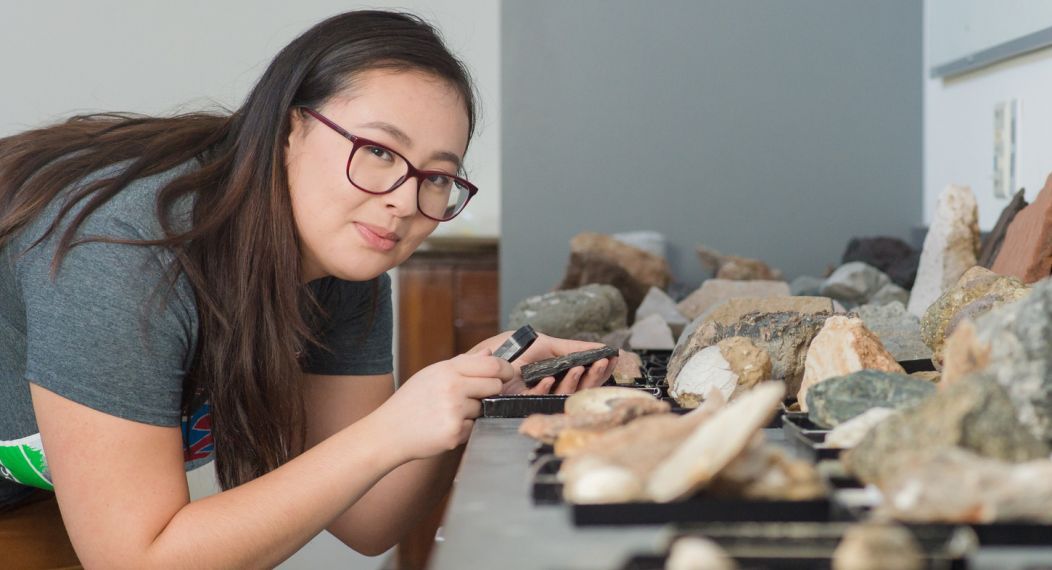 Student studying rocks in classroom