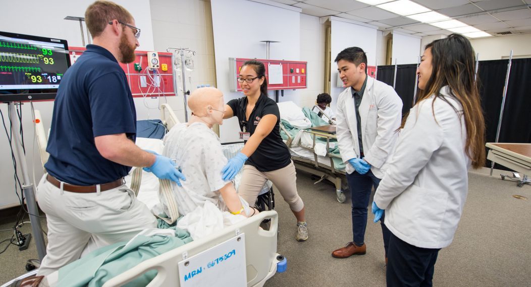 Physical therapy, pharmacy and speech language pathology students run through patient case studies in the simulation lab as part of an interprofessional education program