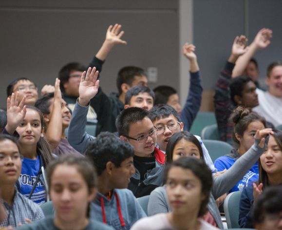 high school students raising hands