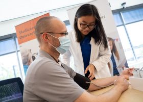 PharmD student taking a patient's blood pressure
