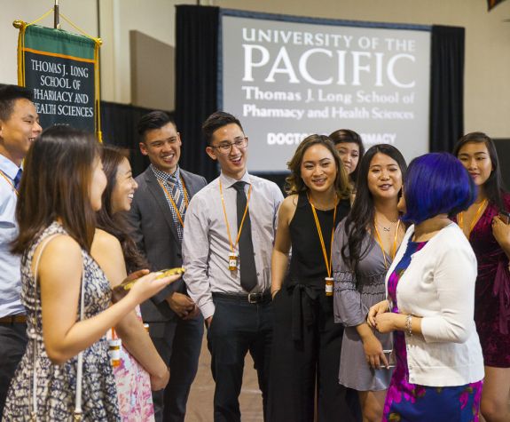 Group of PharmD graduates with a regional coordinator at the annual Pharmacy Graduation Banquet