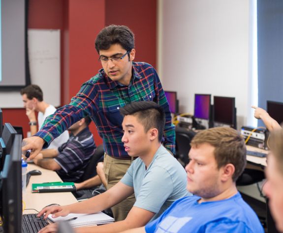 Professor teaching a student in the computer lab