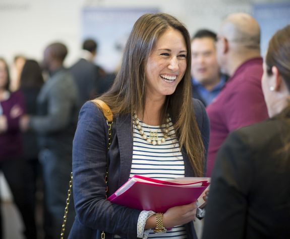 PharmD studnets talks to exhibitor at event in the DeRosa University Center
