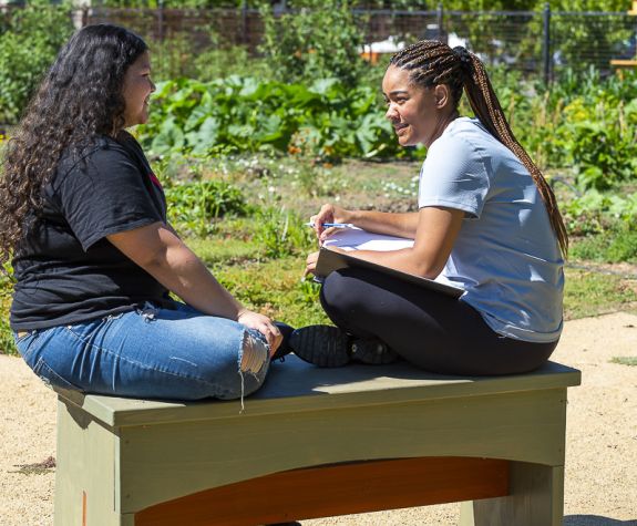 students sitting on bench