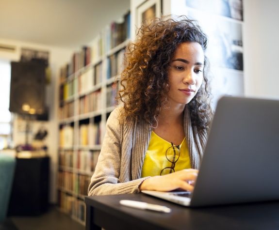 Student on a laptop researching.
