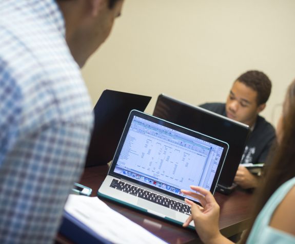 accounting students looking at laptop