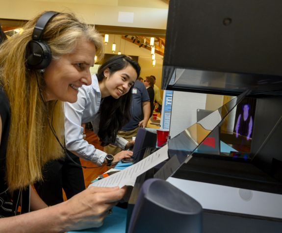 Staff being shown student project.