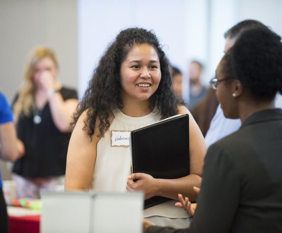 Student speaking with employer at Meet the Firms day