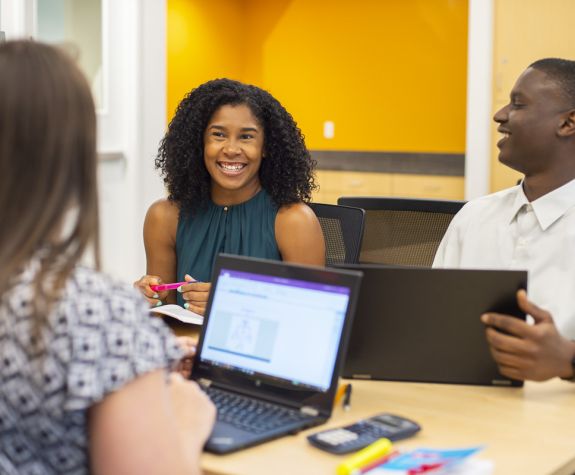 students sitting together smiling at each other