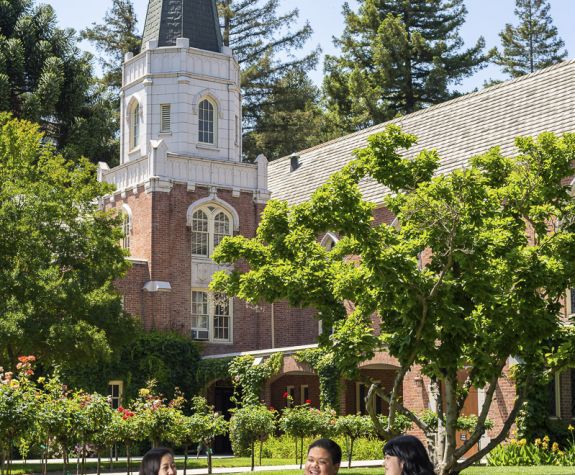 students sitting on lawn next to Morris Chapel