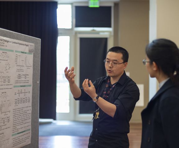Student presenting a research poster