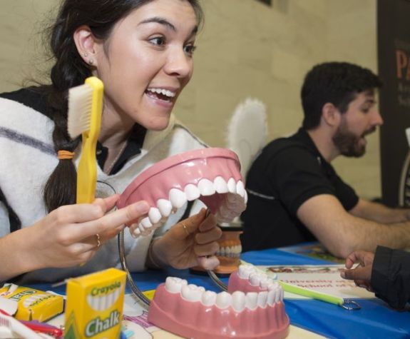 volunteer demonstrating toothbrushing