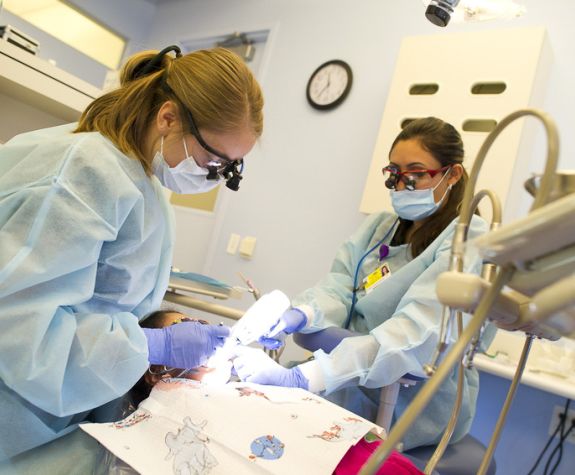 dental students working on a patient