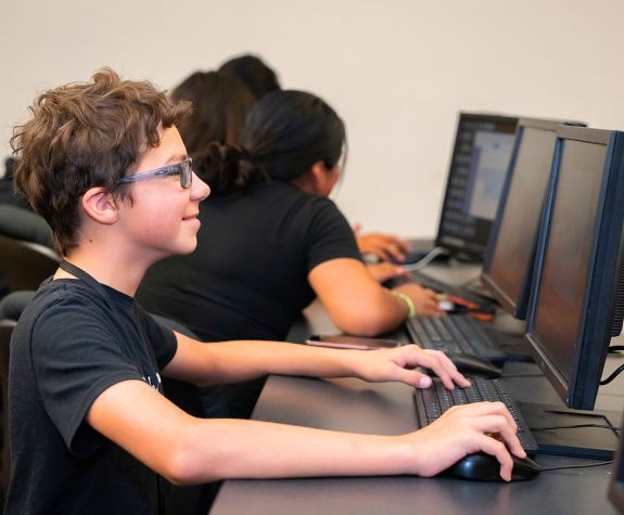 Game Design student working at a computer