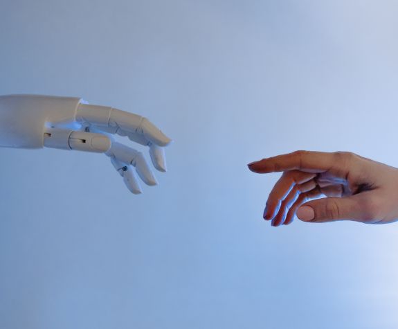 robotic hand reaching for human hand, parody of famous painting