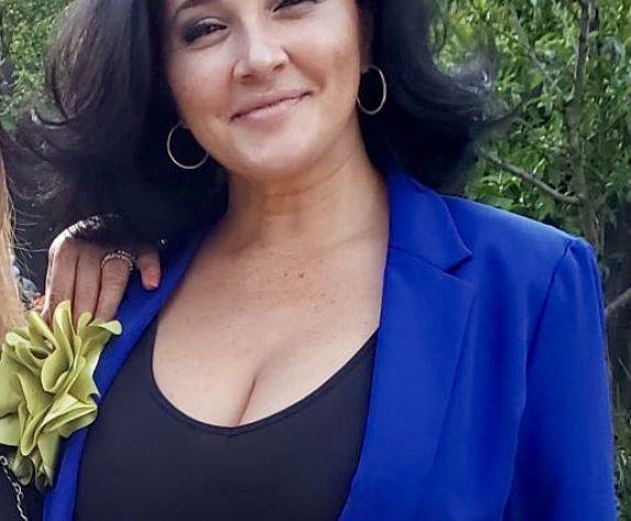 A woman smiles for a photo