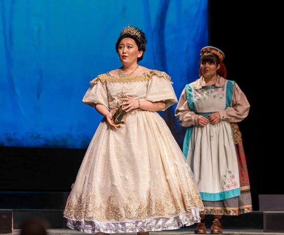 Student actor on stage as Cinderella