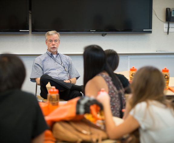 Professor John Livesy in classroom with undergraduate students