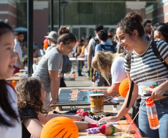 Undergraduate students at a club fair in front of the DeRosa University Center