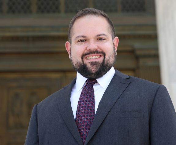 A portrait of a man wearing a suit