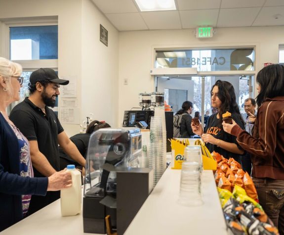 Students making a purchase at the counter in Cafe 1851.