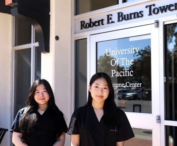 two pre-health students in front of burns tower