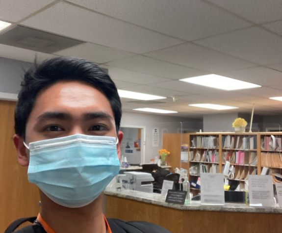 an pre-health student wearing a mask in a health-professions waiting room