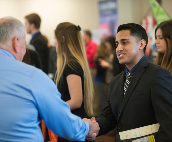 Students meet with future employers at the Eberhardt School of Business career fair.