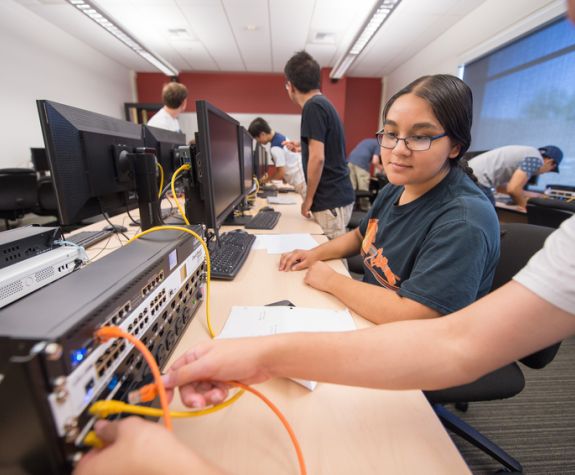 Cybersecurity student works on a computer in the lab