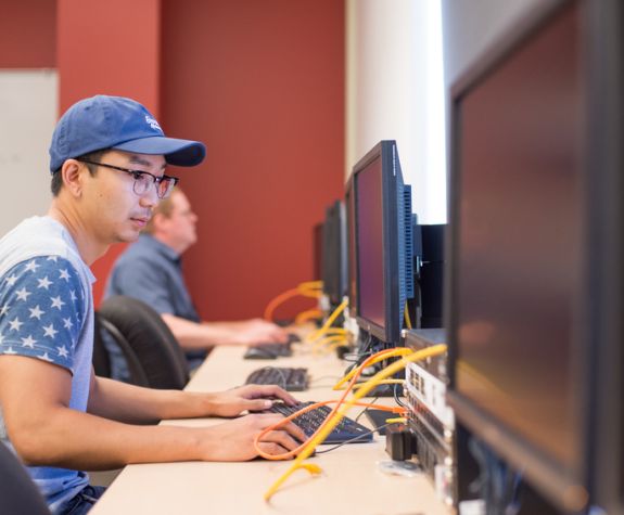 Student works on computer in Cybersecurity class