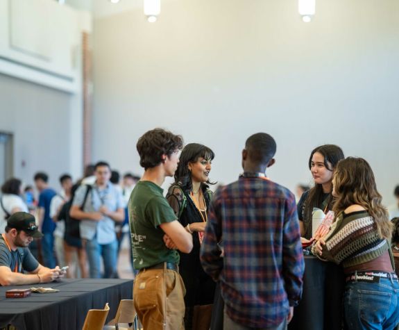 a group of Pacific students talking during orientation