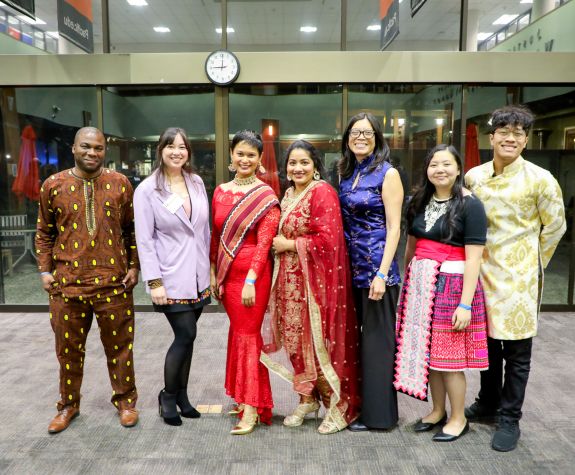 a group of individuals wearing traditional attire posing for a photo