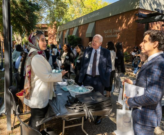 students outside talking to an employer