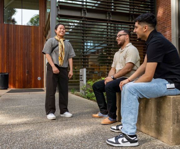Occupational Therapy students converse in front of the library on Pacific's Sacramento campus.
