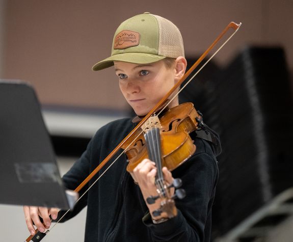 A violin student playing