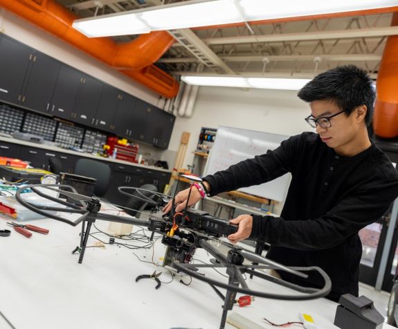 Pacific computer engineering student working on a drone