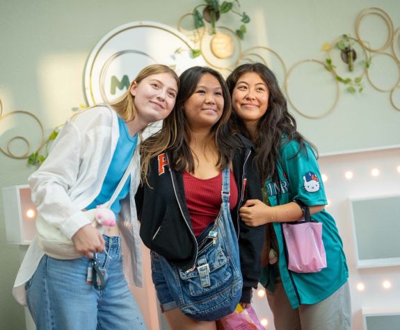 three students pose together