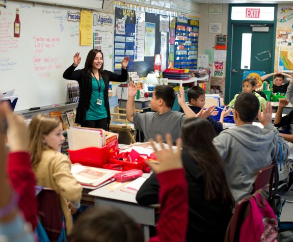 Benerd student teacher guides students through interactive learning in the classroom.