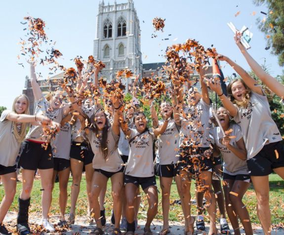 Many students cheering and throwing confetti