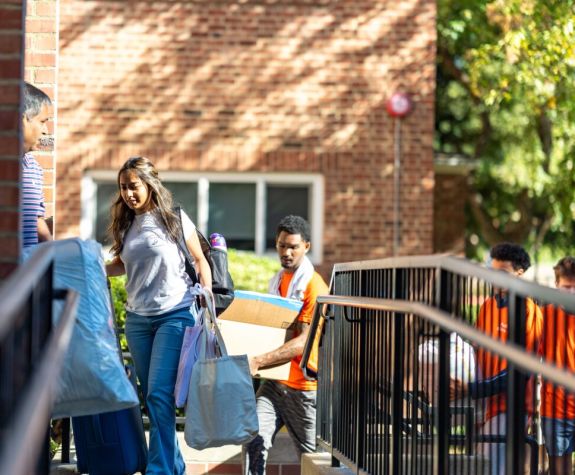 students move into a dorm building