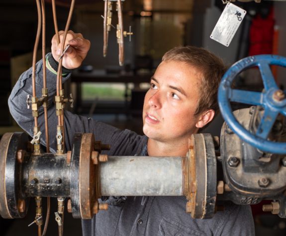 a student works with water pipes